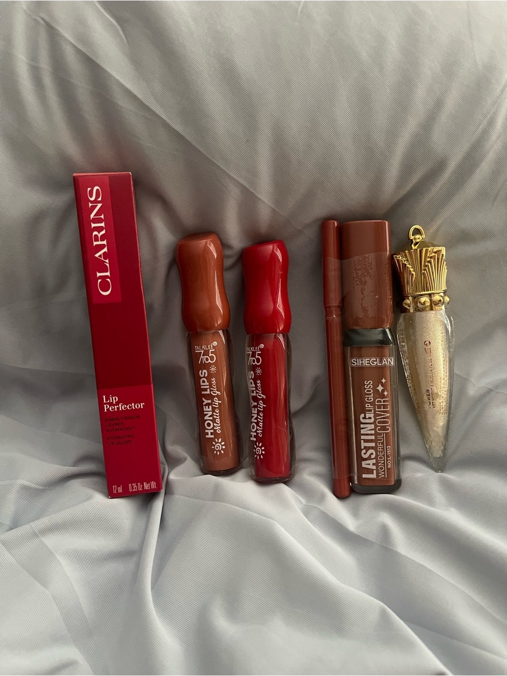 Clarins Lip Perfector with Red and Brown Lip Tints lips oils